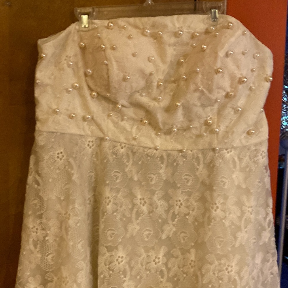 It’s a beautiful only worn once knee length strapless dress and hand sewn pearls
